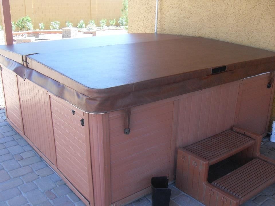 Brown custom spa cover fitted on a backyard hot tub