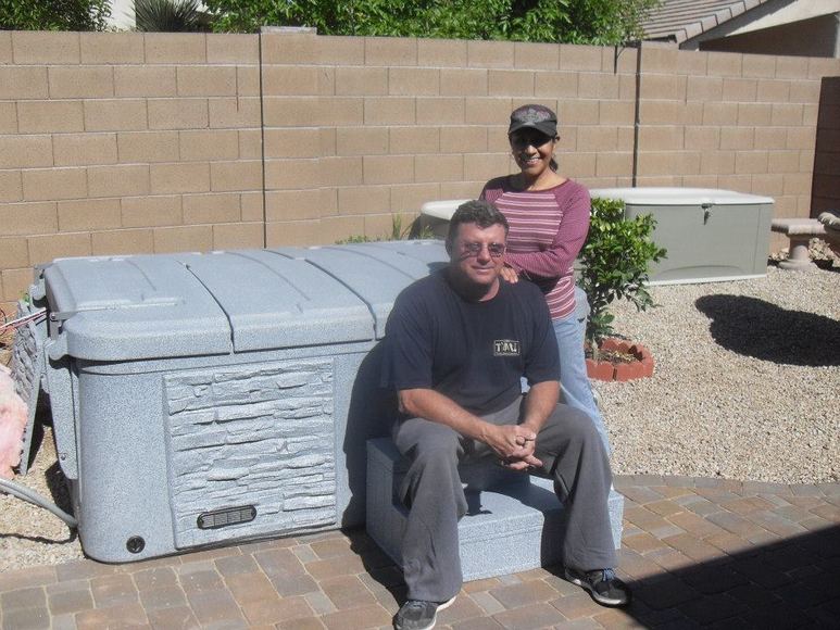 Customer seated beside his spa after delivery